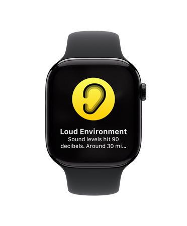 Pohled zep?edu na Apple Watch Series 10 s bílym sportovním ?emínkem, na displeji se zobrazuje ikona upozornění na vysoky hluk s textem Hlu?né prost?edí, úroveň hluku dosáhla 90 dB.