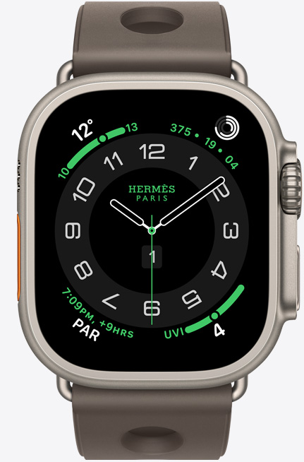 Apple Watch Hermès Ultra 3, titanium case, natural color, Hermès Circulaire watch face, complications: weather, activity rings, PAR, UV index, right side exterior, Digital Crown, microphone, raised side button, Scub'H Diving band, gris titane color
