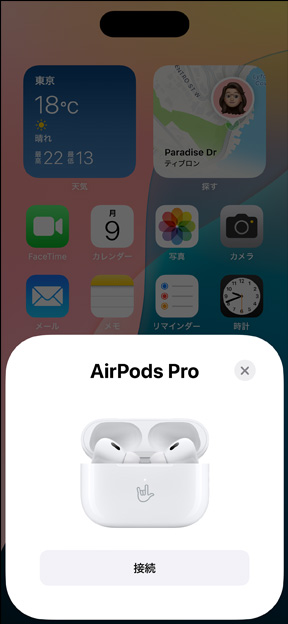 AirPods Pro 2が入ったMagSafe充電ケースがiPhoneの隣にある。iPhoneのホーム畫面上に小さなタイルがポップアップ表示されている。タイルには、タップすると簡単にAirPodsをペアリングできる「接続」ボタンがある