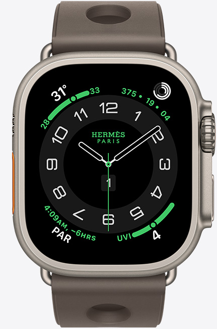 Apple Watch Hermès Ultra 3, titanium case, natural colour, Hermès Circulaire watch face, complications: weather, activity rings, PAR, UV index, right side exterior, Digital Crown, microphone, raised side button, Scub’H Diving strap, gris titane colour