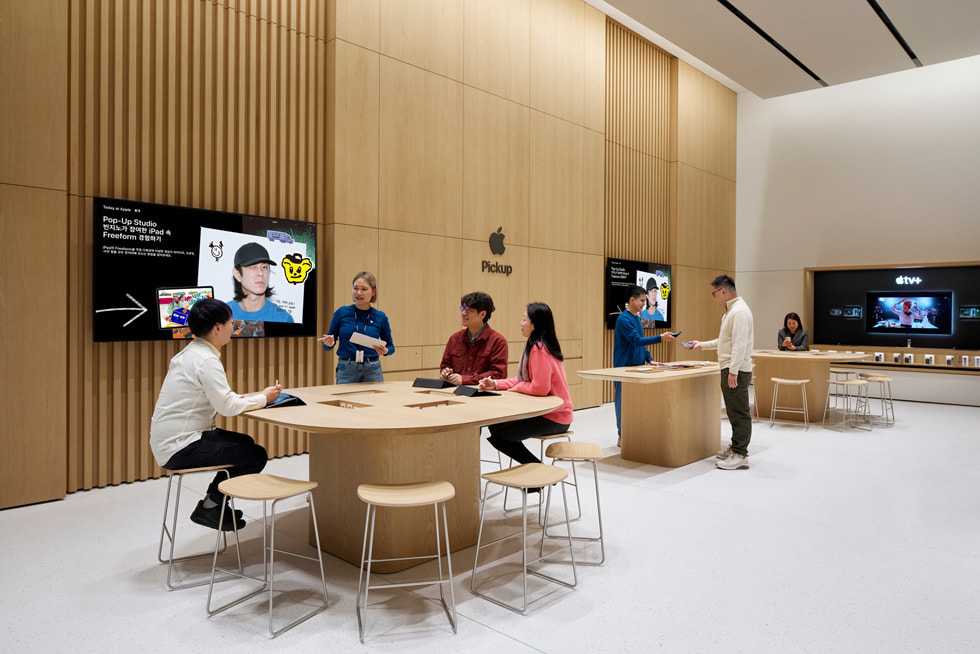 Khách hàng ?ang ng?i ? bàn Today at Apple bên trong c?a hàng. 