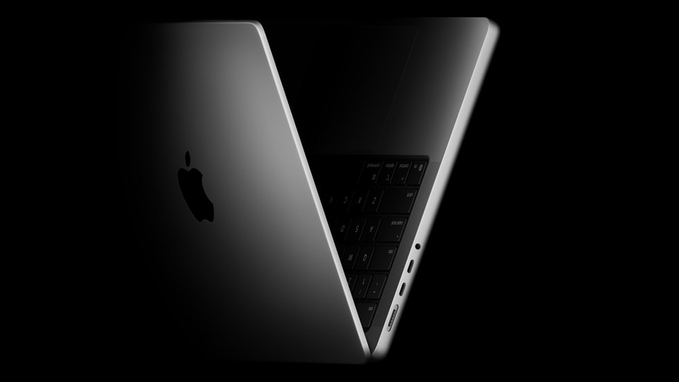 The new 14-inch MacBook Pro shown propped open and angled to the side.