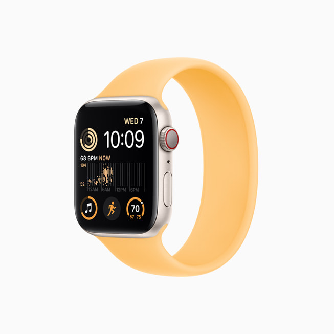 Apple Watch SE v? nh?m màu ánh sao v?i Day Solo Loop màu n?ng mai.