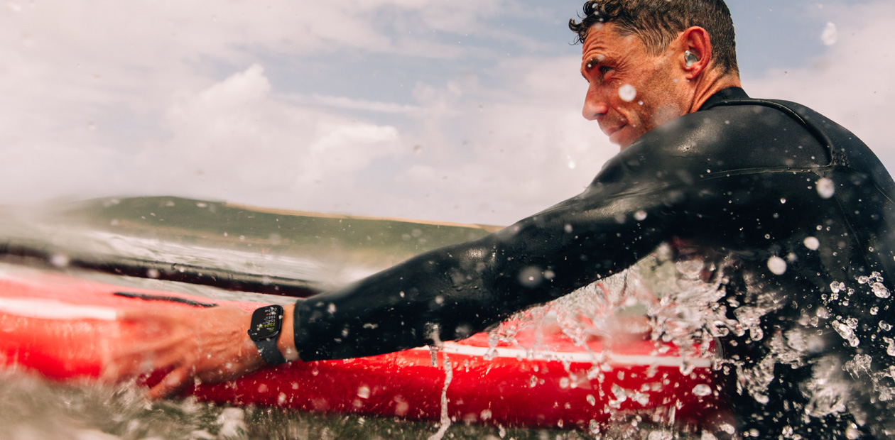 En mann surfer mens han har p? seg en Apple Watch.