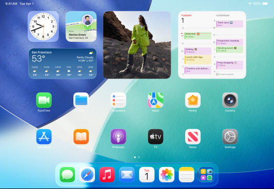 iPad, three models, landscape orientation, with centre model in front of two others, Apple Pencil magnetically attached to top of centre model, centre screen showing the Home Screen featuring colourful app icons with Liquid Glass effect, left screen showing the Preview app, right screen showing Home Screen with files fanning out from the dock