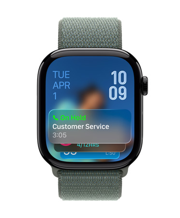 Apple Watch in Jet Black with Sage Band, Face shows Hold assist notification at bottom, date on top left, time numerals stacked at top right