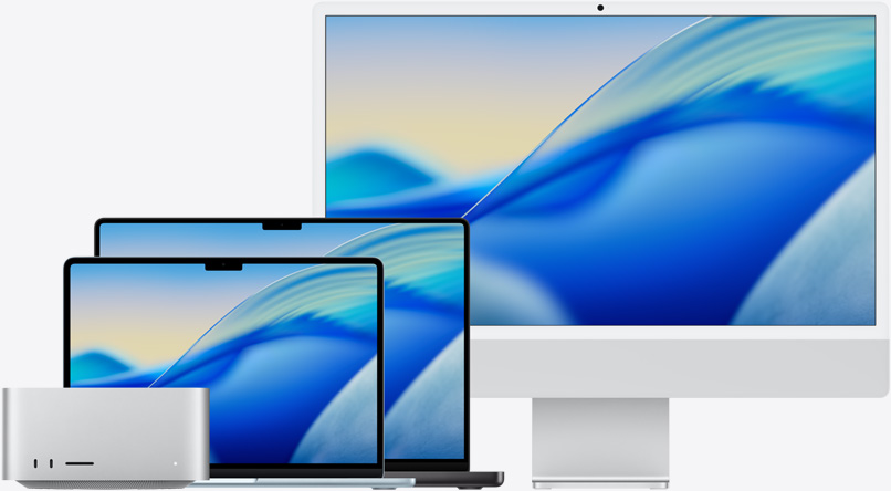 The macOS Tahoe wallpaper across a family of Mac models from left to right: Mac Studio, 13-in MacBook Air in Sky Blue, 14-in MacBook Pro in Space Black and 24-in iMac in Silver