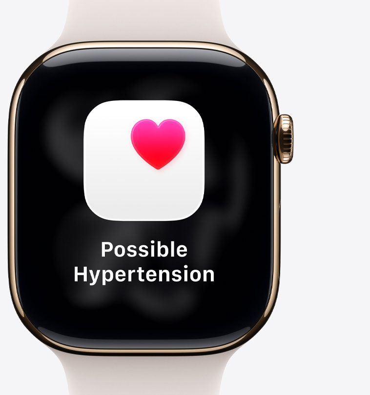Apple Watch Series 11, titanium case, polished gold color, possible hypertension notification, pink heart in white box, right side exterior, Digital Crown, light blush Sport Strap
